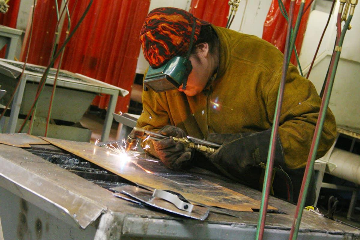 Student focuses on weld bead during shop time.